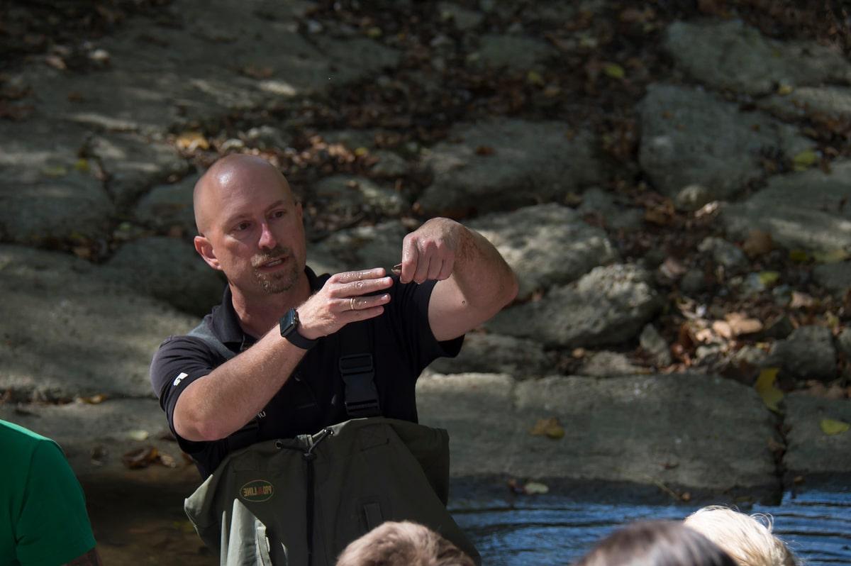 Curt Coffman teaching his students in the middle of the woods